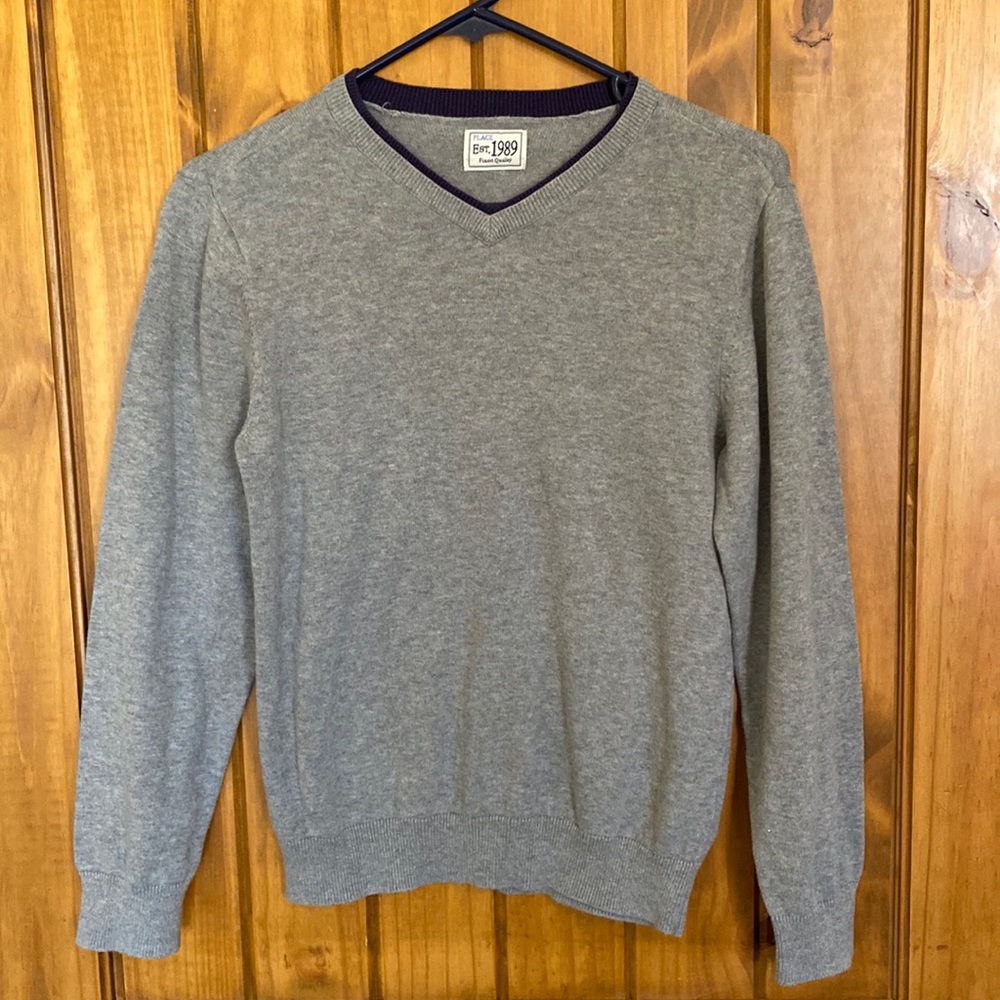 Gray boys sweater with navy collar accent.